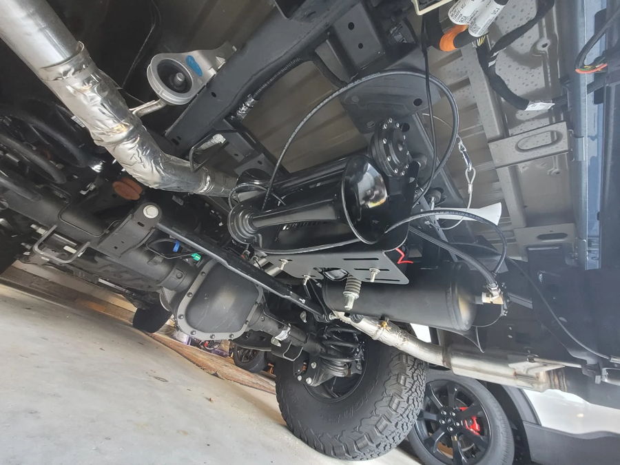 Underside view of train horn and air tank installation on Ford F150
