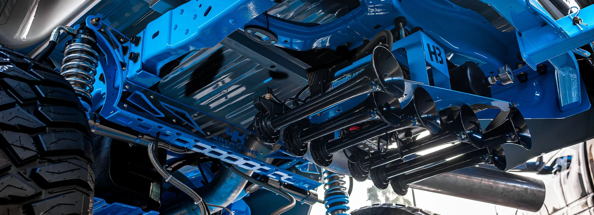 HornBlasters train horns mounted on a custom blue truck undercarriage