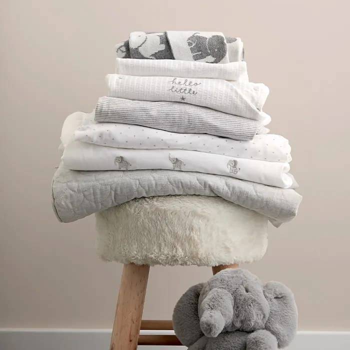 Mixture of Welcome to the World blankets on stool 