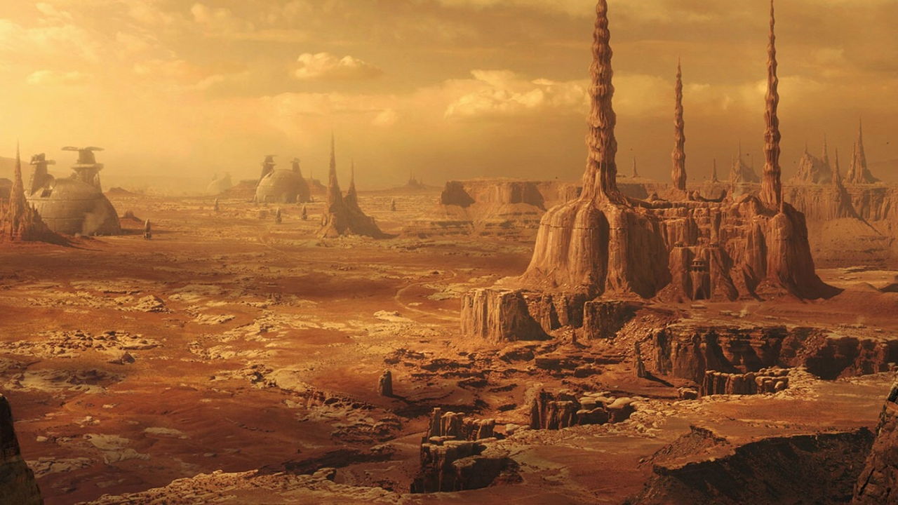 A barren, reddish landscape with towering rock formations under a cloudy sky.