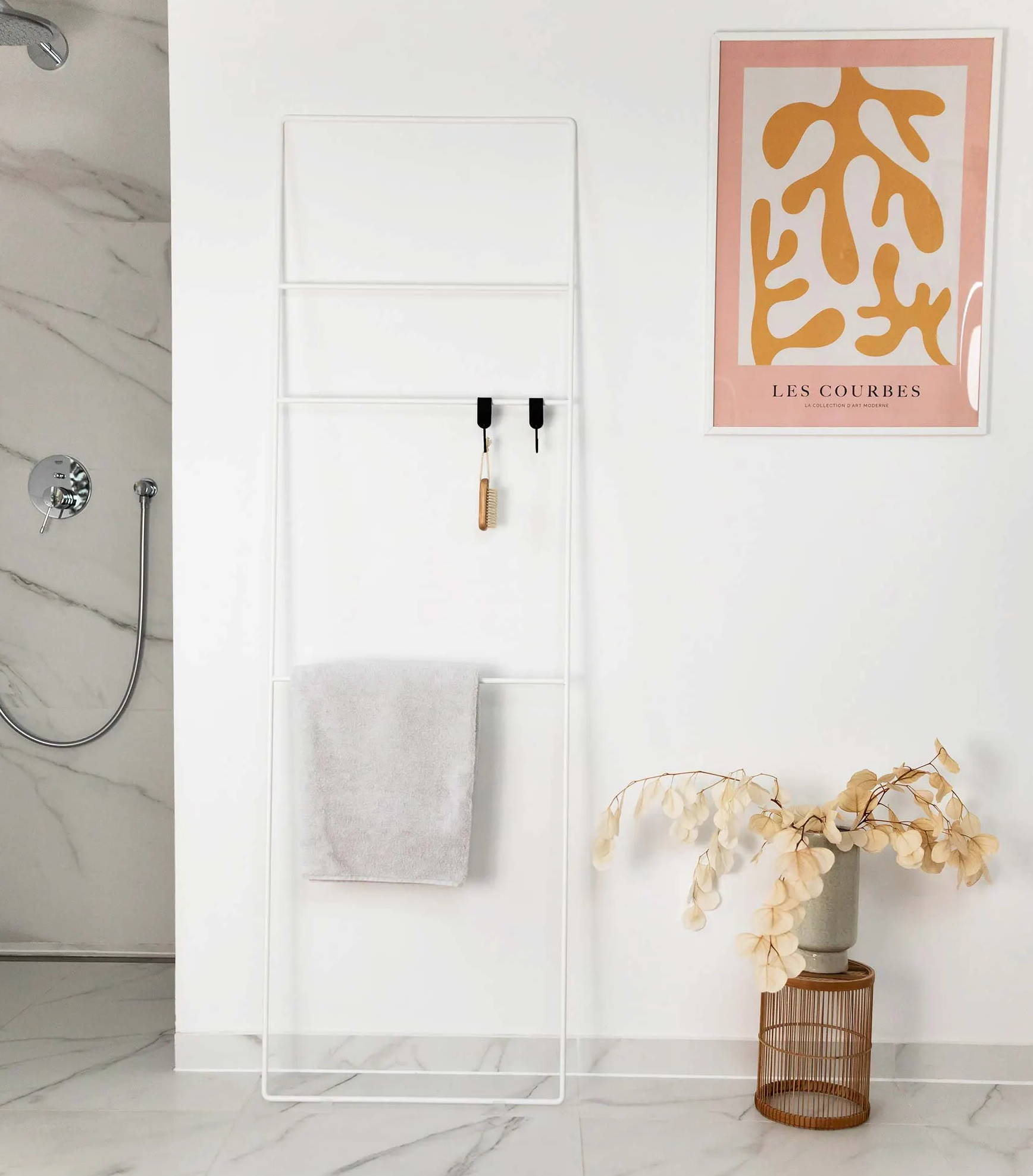 White towel ladder in minimalist bathroom | metal booth
