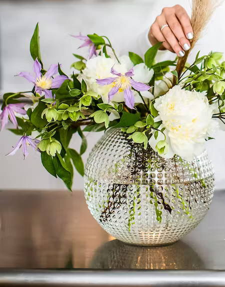 Woman arranging flowers in vase