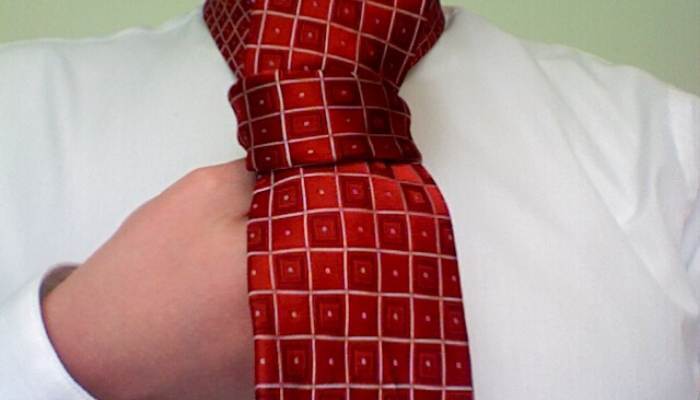 Closeup of a four in hand tie being tied