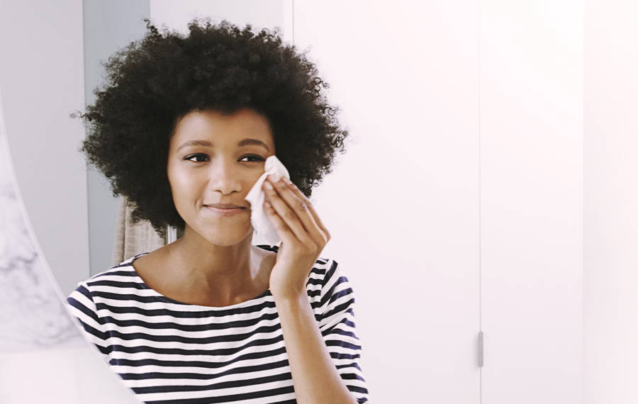 woman using jojoba oil to cleanse her face