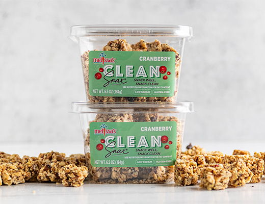 Two containers of cranberry granola with scattered pieces on a light background.