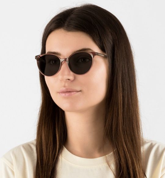 woman wearing Felicity Pink sunglasses, oval frame sunglasses for heart shaped faces, on a white background