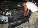 Installer working behind radiator bumper removed V6 engine Wesley's 2008 RAV4 Conductor's Special 228H horn mount gallery photo 5