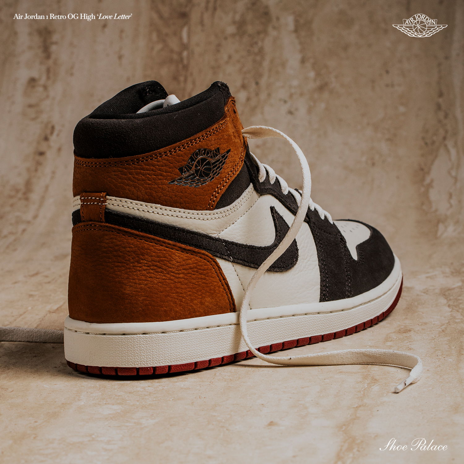 High-top sneaker with black, white, and brown color scheme on textured background.