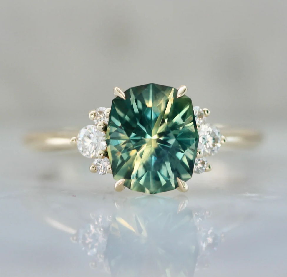 custom engagement ring with geo cut green sapphire and half halo of diamonds in 18kt yellow gold by gem breakfast