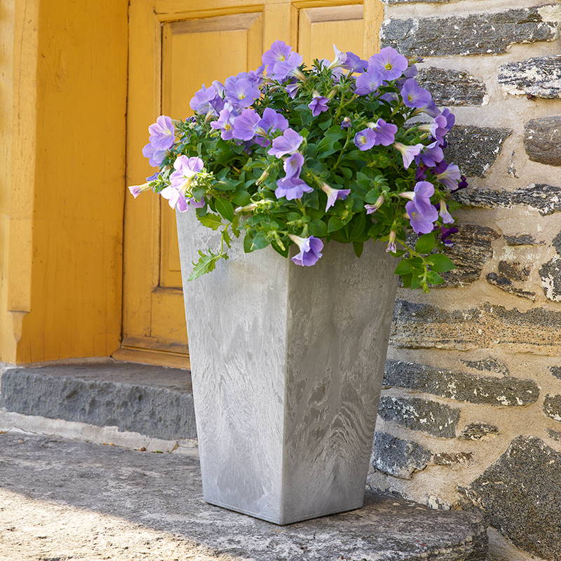 Gray Ella tall planter with flower in it