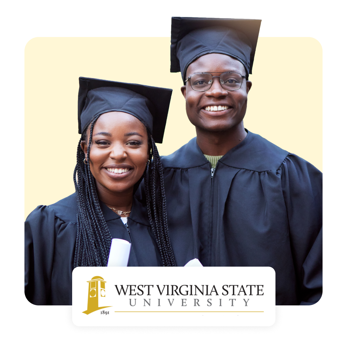 Two graduates in caps and gowns smiling together at West Virginia State University.