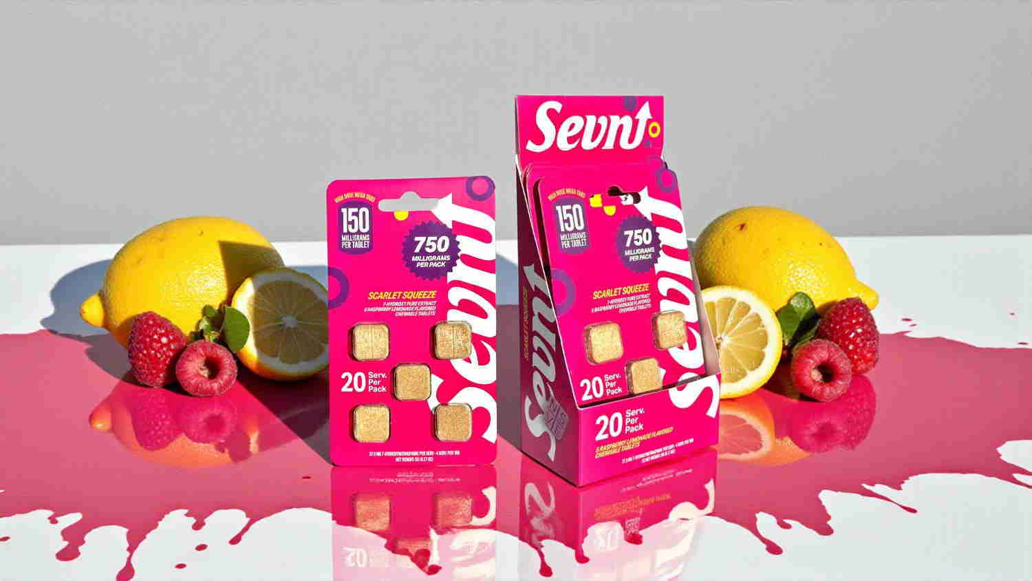 Two boxes of candy with lemons and raspberries, surrounded by pink liquid.