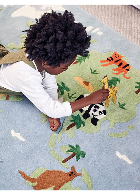 Young boy playing on Around the World rug