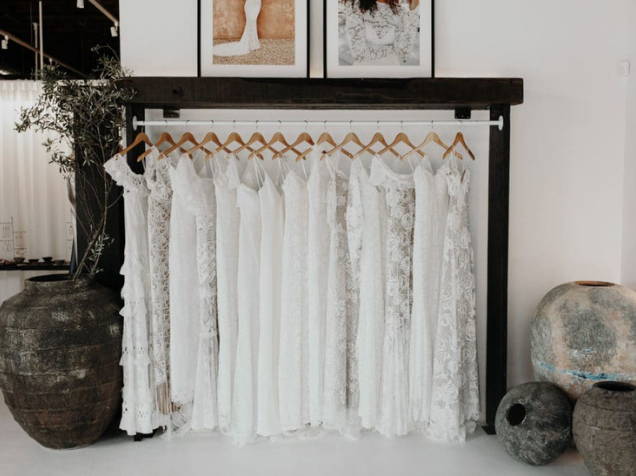 Rustic ceramics and rack of Grace Loves Lace ready-to-wear dresses