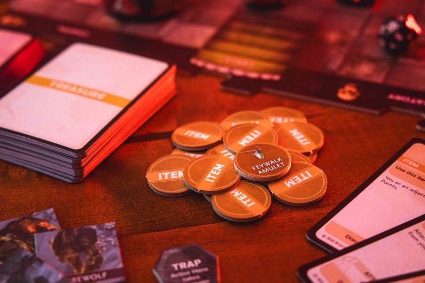 Board game components including cards and tokens on a table.