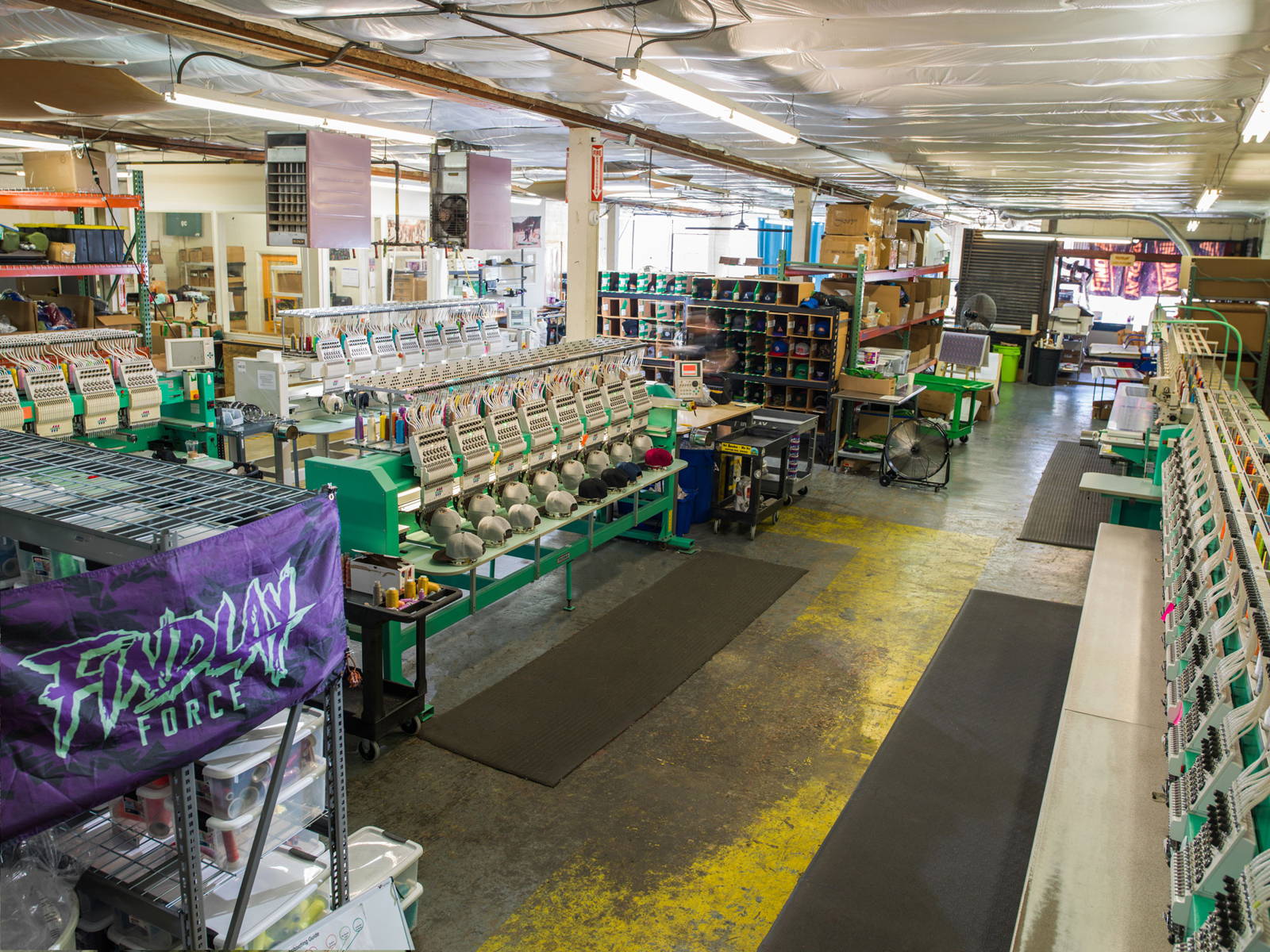 The Findlay warehouse floor with rows of embroidery machines and work stations.