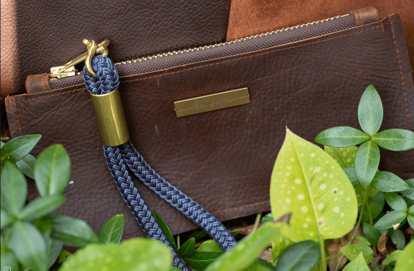 closeup on leather clutch with navy wristlet