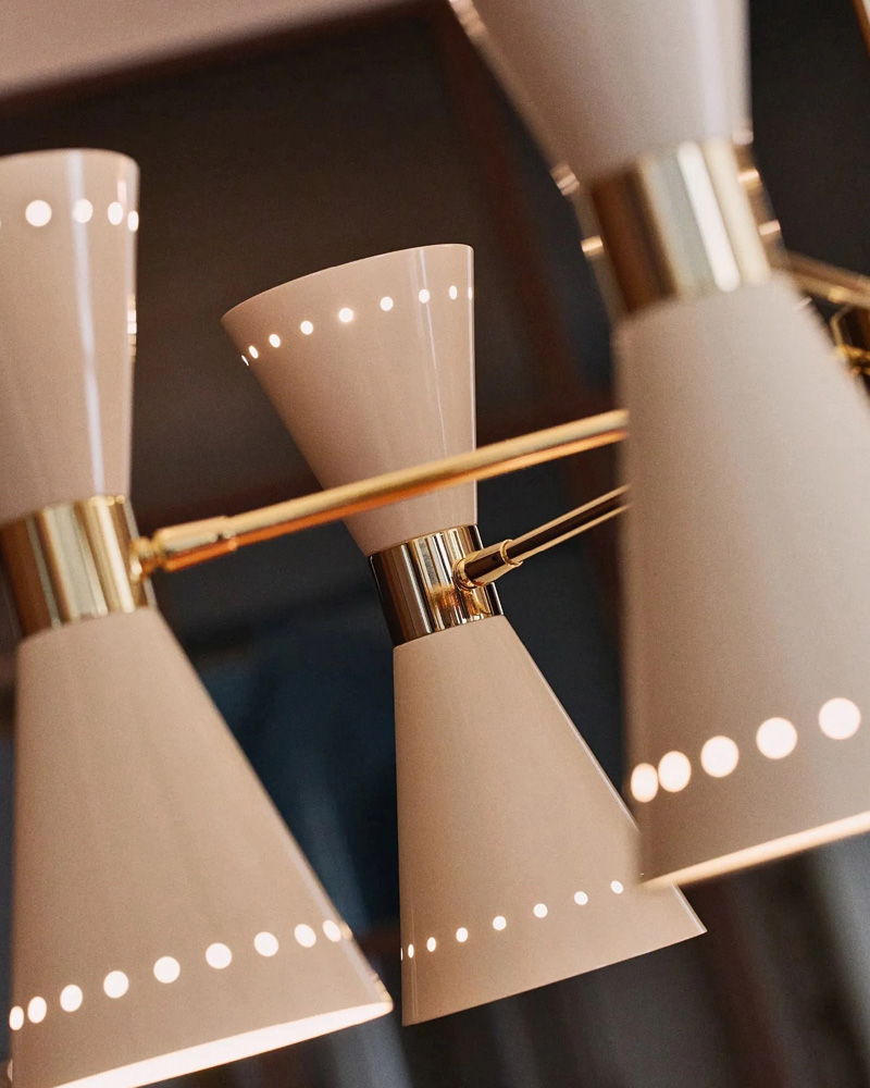 Close-up of modern Stilnovo light fixtures with a beige and gold design.
