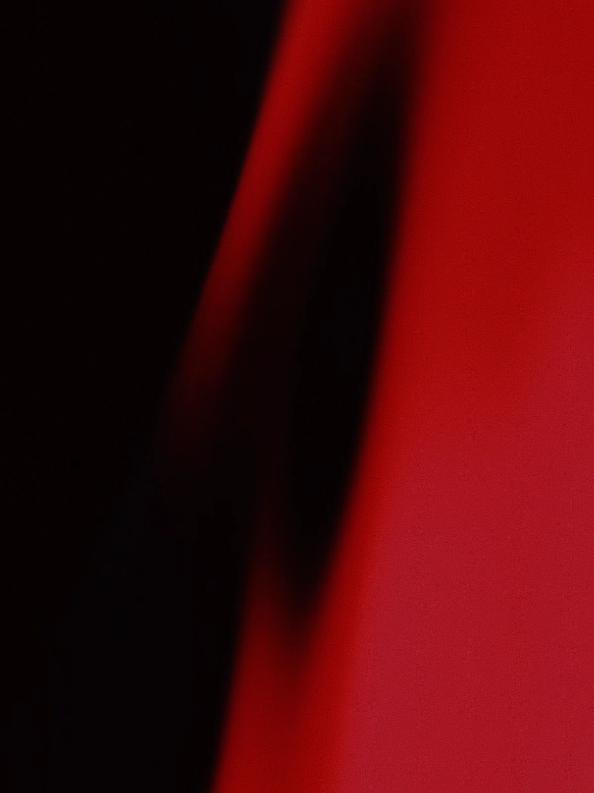Abstract red and black gradient with soft curves and shadows.