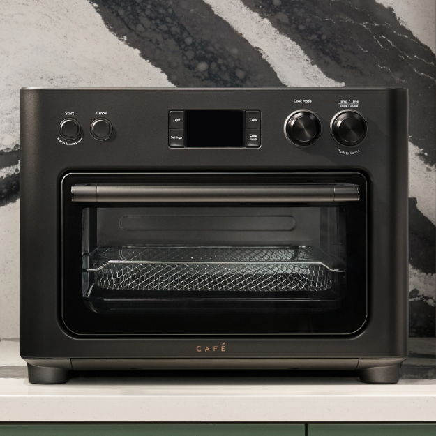 Black air fryer oven with digital display and control knobs.
