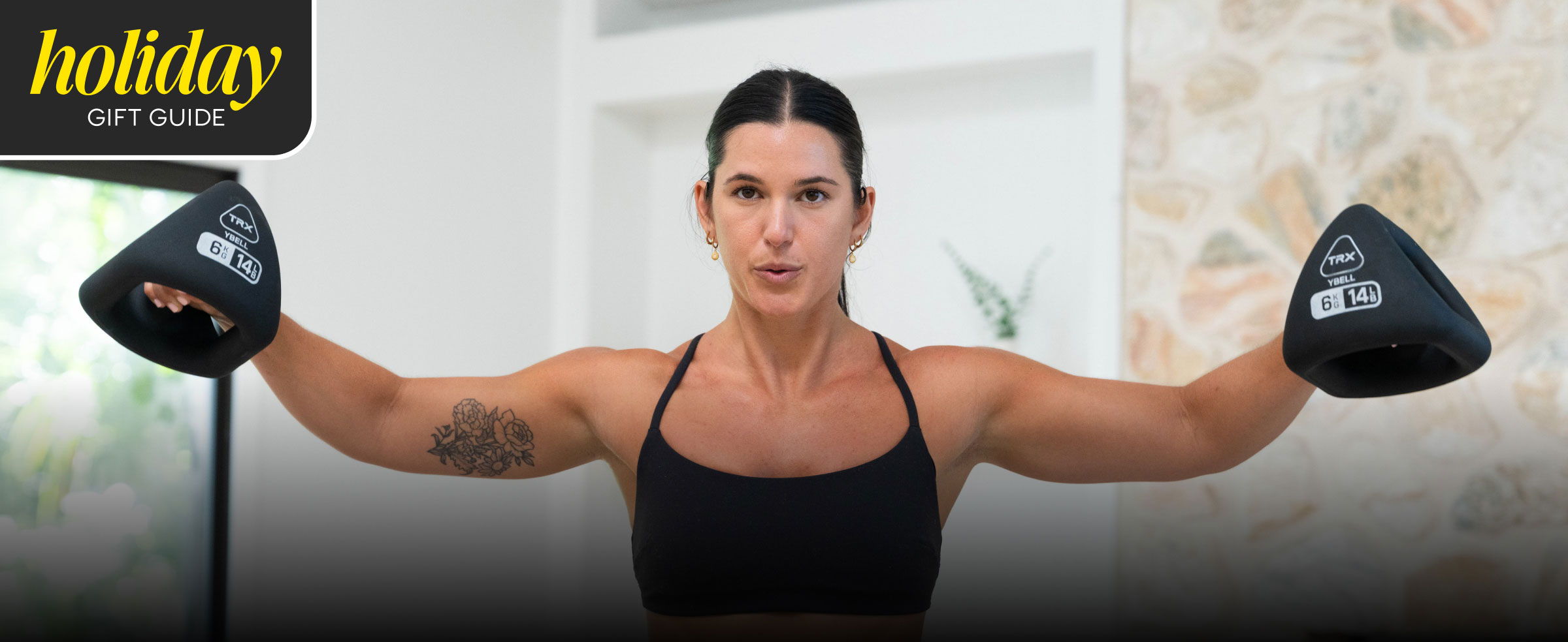 Woman exercising with weights in a bright indoor setting.