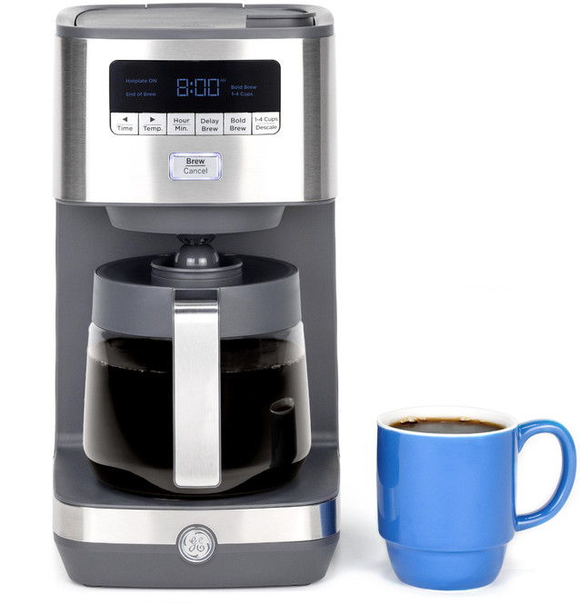 Coffee maker with a black carafe and a blue mug beside it.