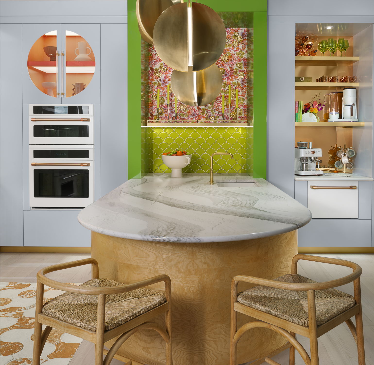 Cafe kitchen with marble island, green accents, and stylish cabinetry.
