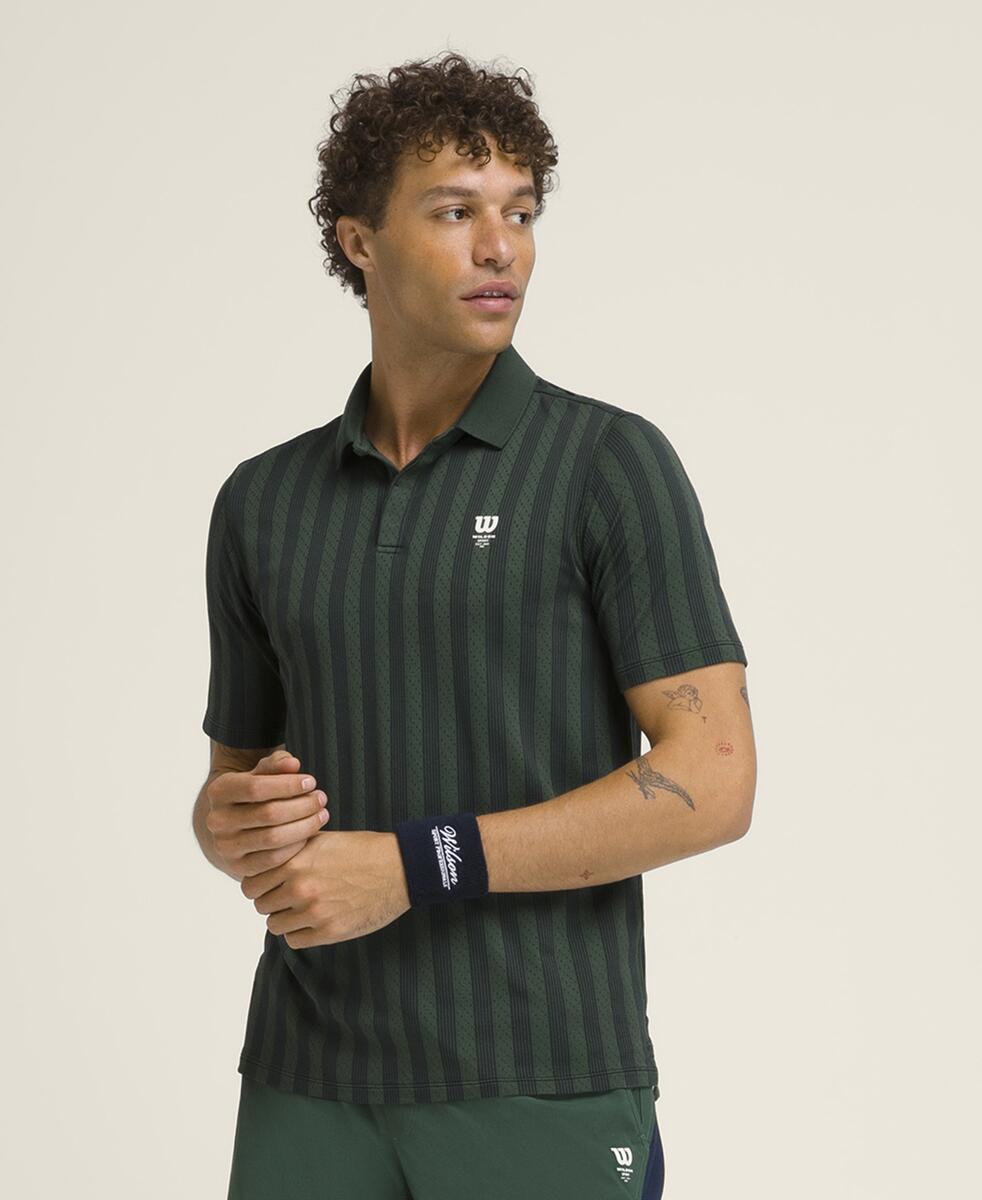 A young man wearing a green striped polo shirt, looking to the side.
