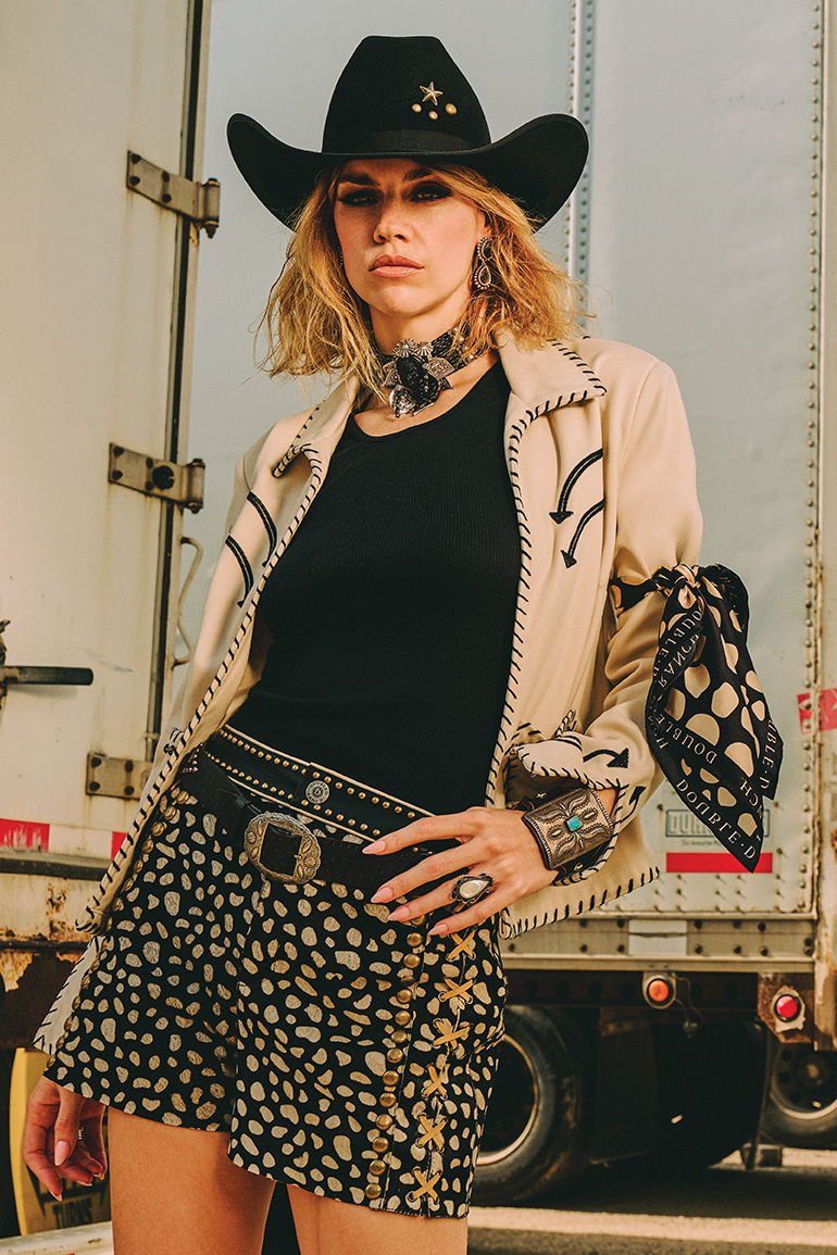 Lozzie wearing the Underground Hootenanny Jacket with the Howdy Dotty Scarf and Short with Double D Ranch jewelry and accessories.