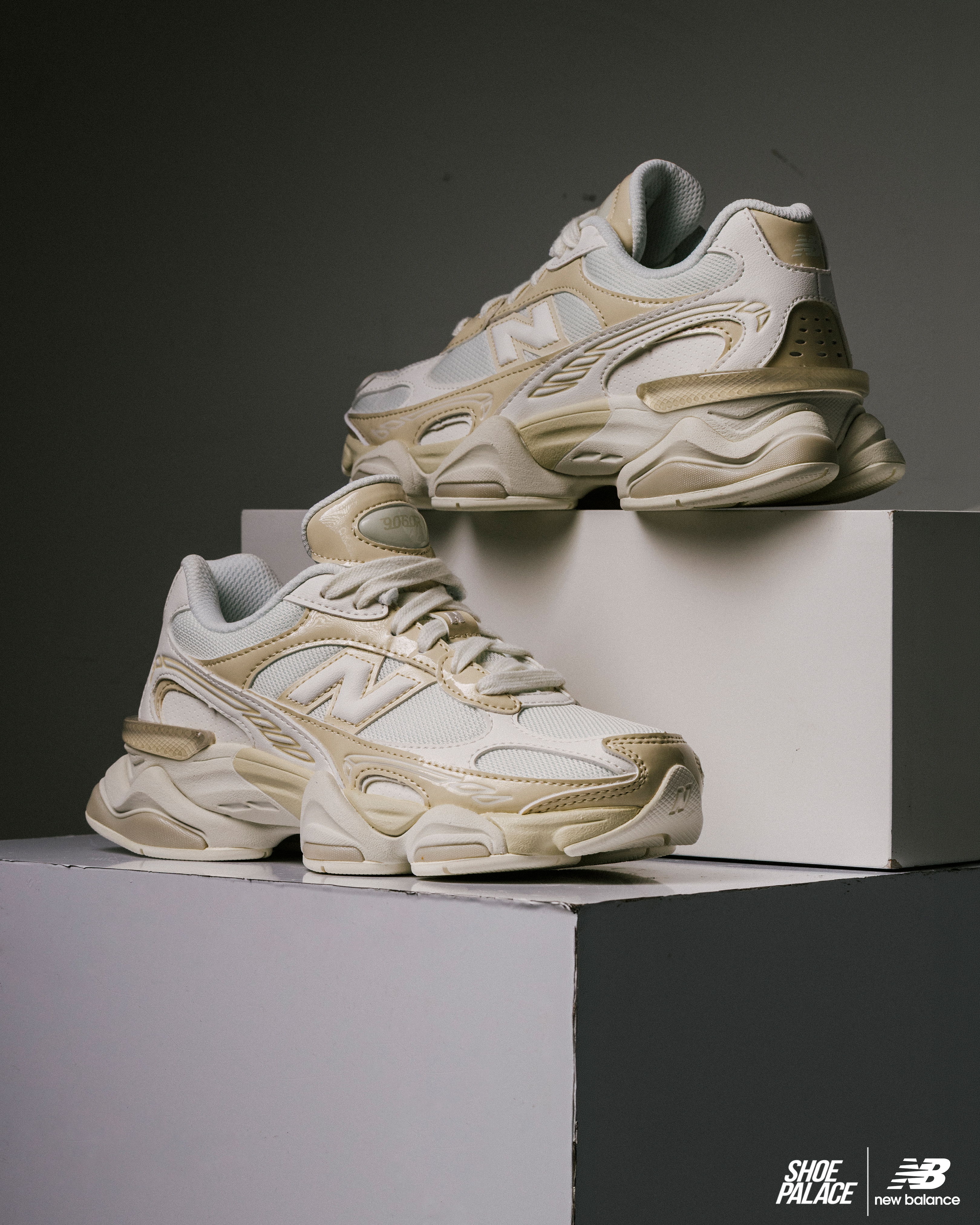 Stylish New Balance sneakers displayed on geometric pedestals against a dark background.