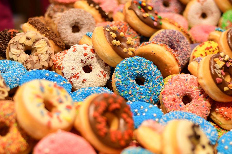 Image of colourful donuts with sprinkles.