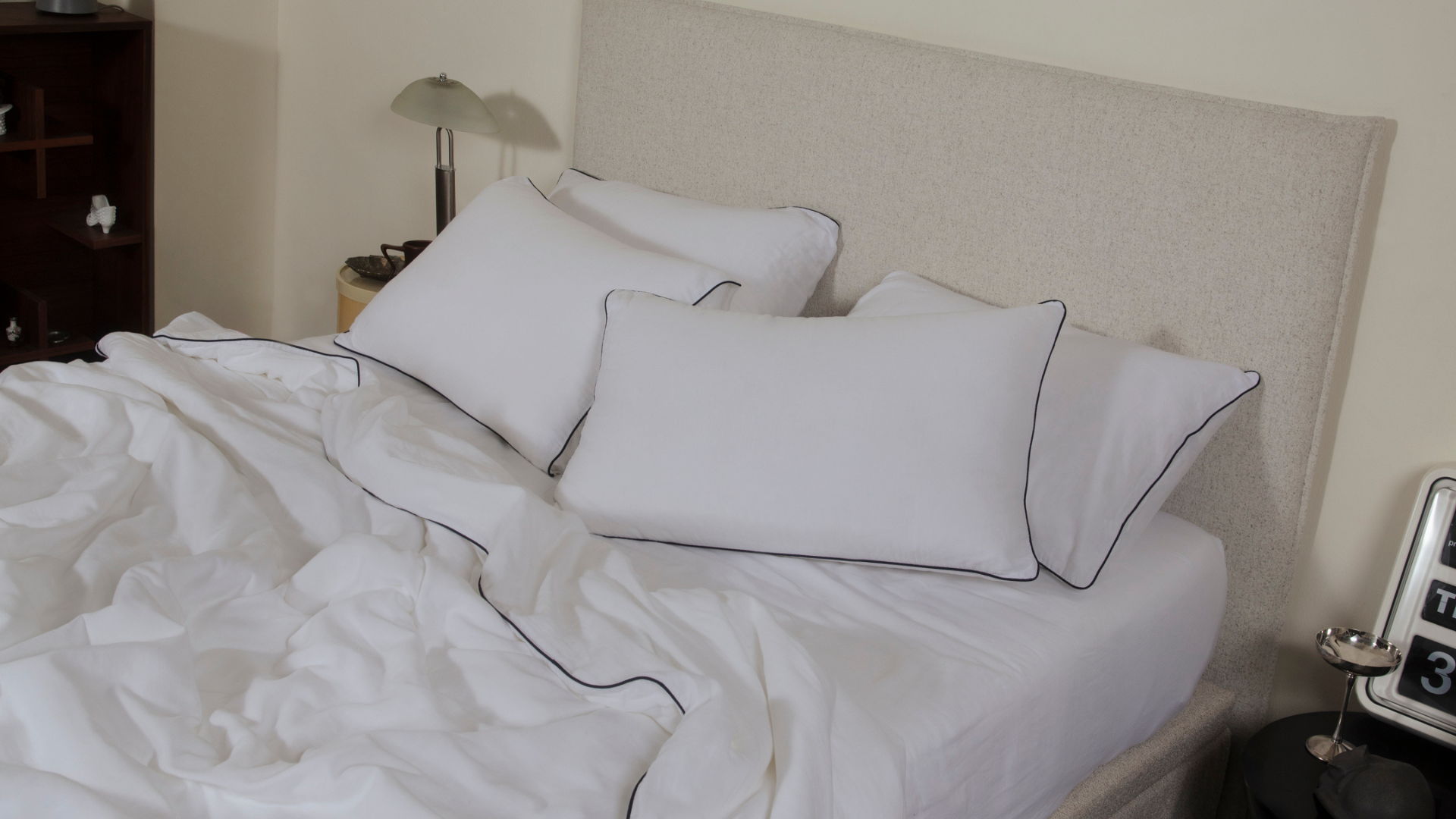 white cotton bedsheets featuring a black piping 
