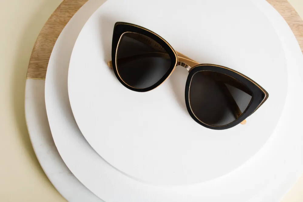 Willow, Bamboo Cat Eye Oversized Sunglasses placed on 2 stacked plates