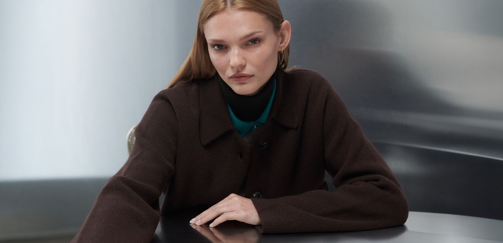 Woman in sweater with reflective background