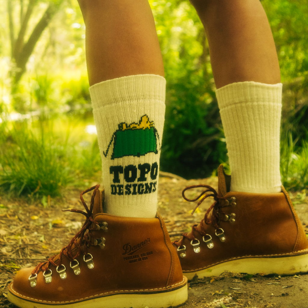 Person wearing brown boots and white socks with 