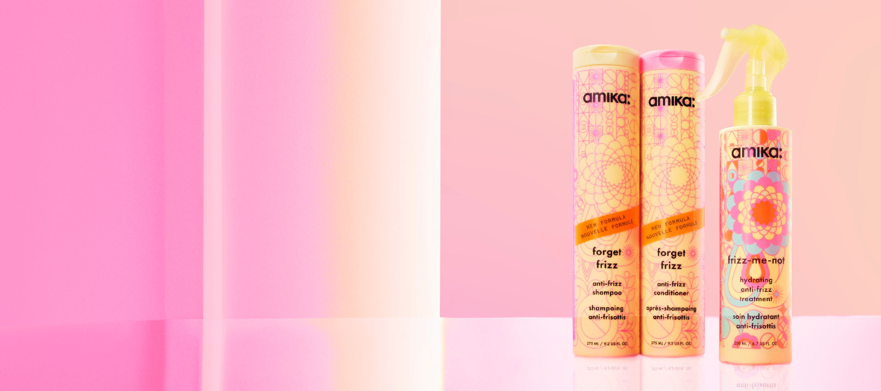 Three hair care products displayed against a pink background.