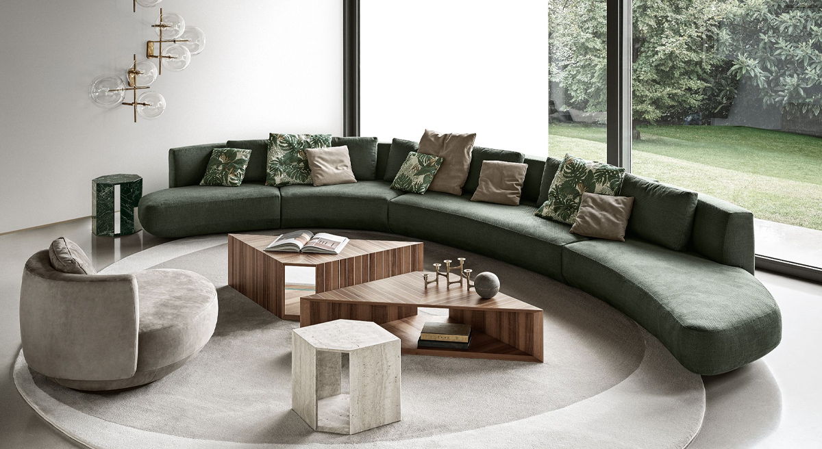 Modern Gallotti and Radice living room with curved green Audrey sofa and geometric coffee table.