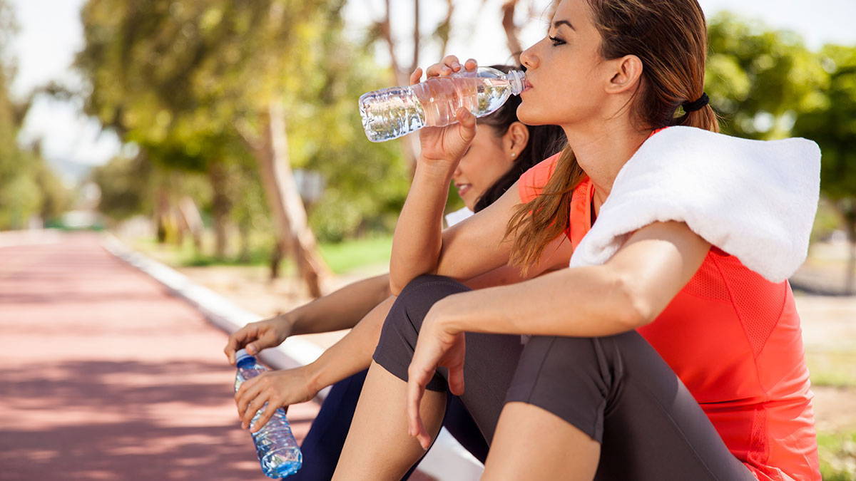 Women drinking water after workout