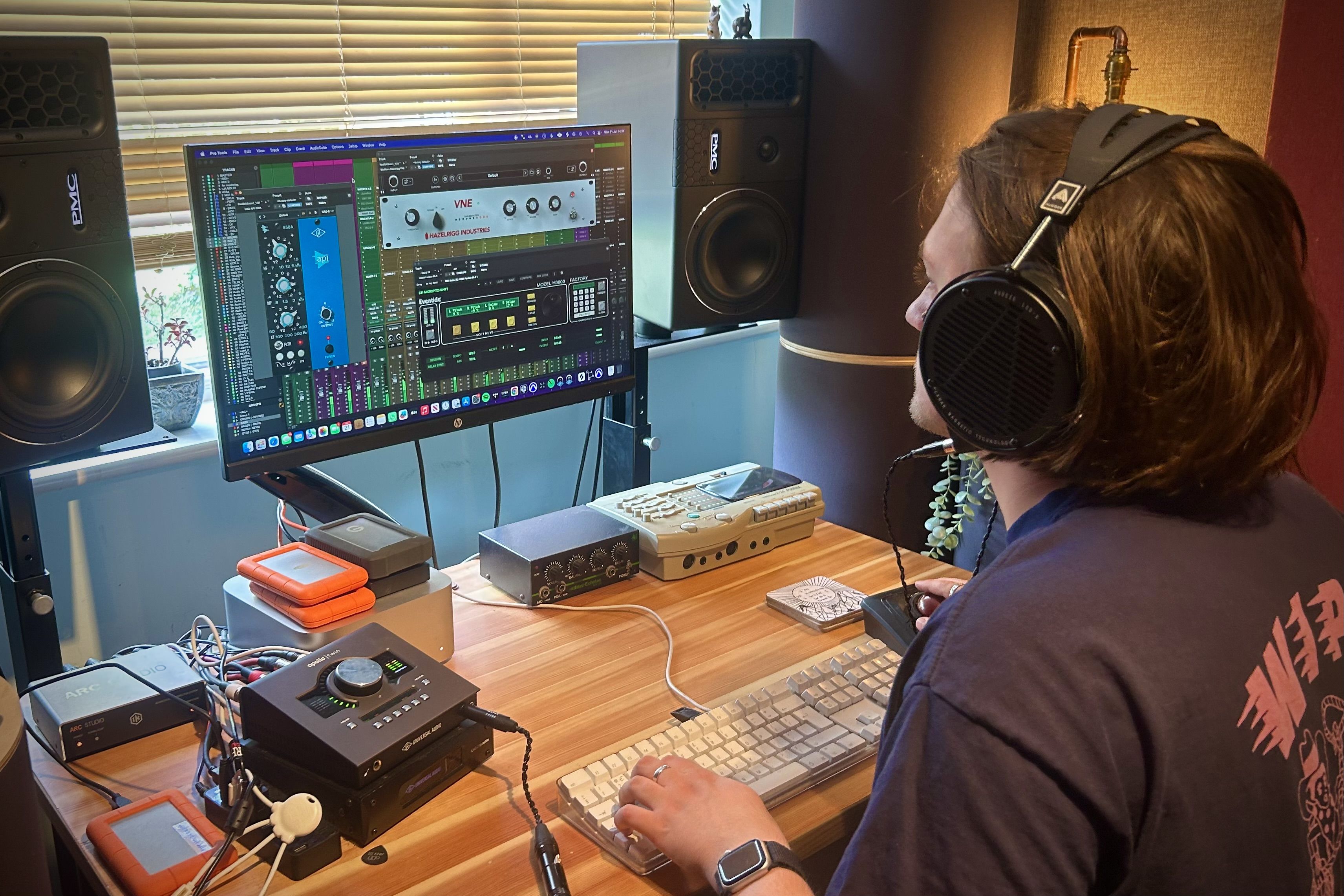 Josh ager wearing Audeze LCD-X headphones working on music production at a computer.