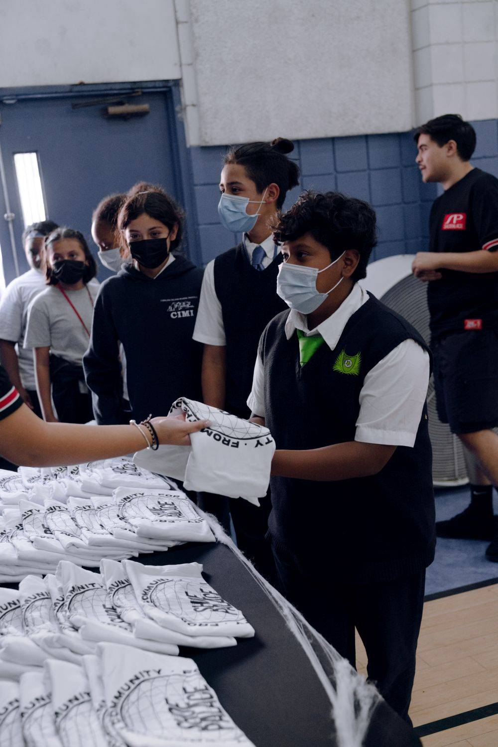 kids picking up sp shirts