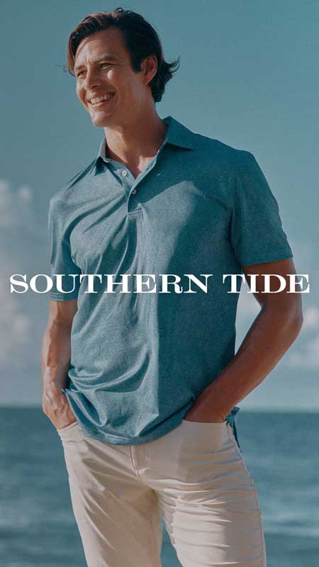 Young man wearing polo and pants on a beach