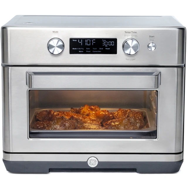 Stainless steel air fryer oven with digital display and food inside.