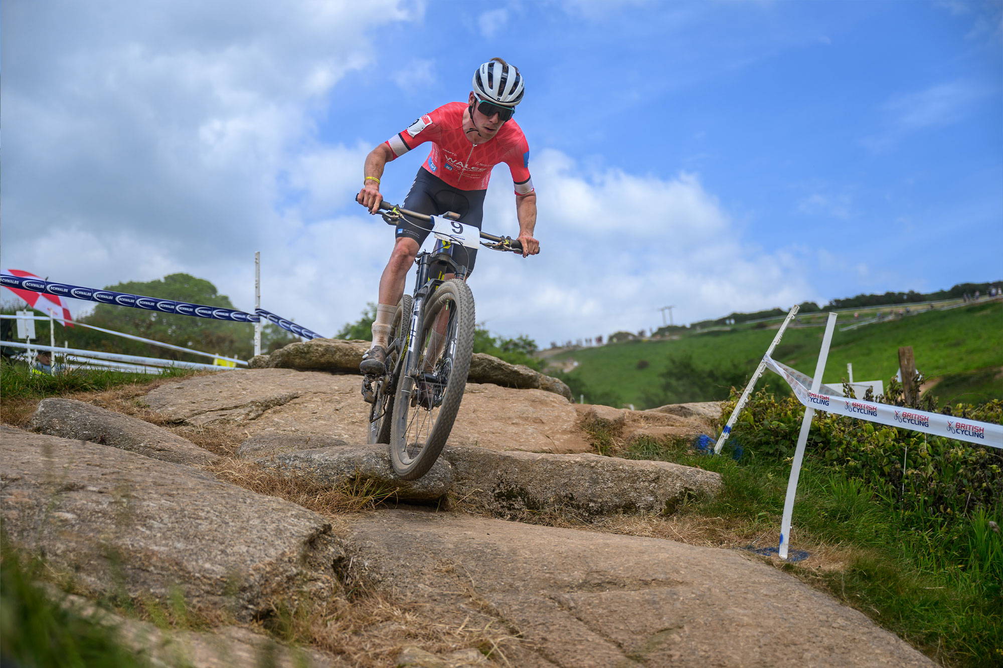 Huw riding over rocky section at XC race