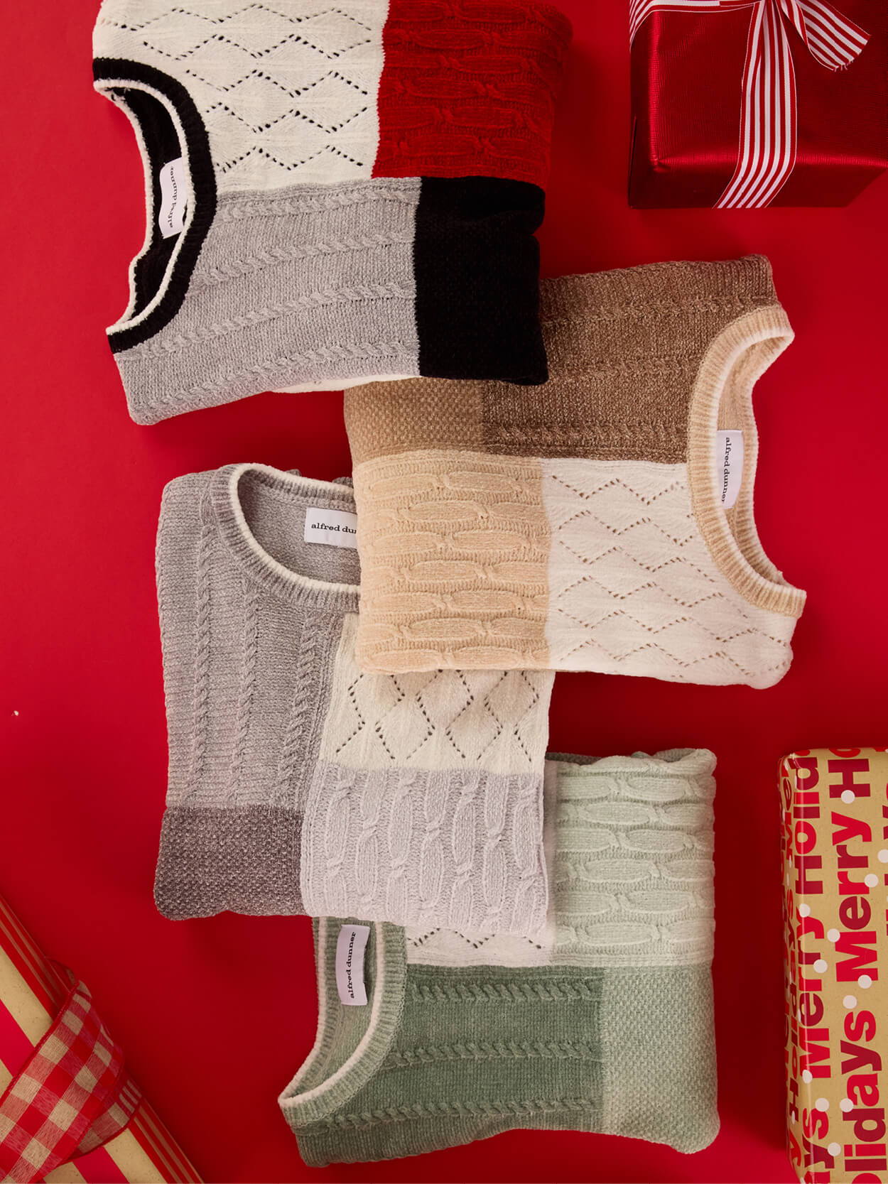 A collection of knitted sweaters on a red background with a gift.