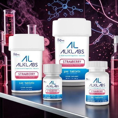 Bottles of ALKLABS strawberry tablets on a laboratory-themed background.