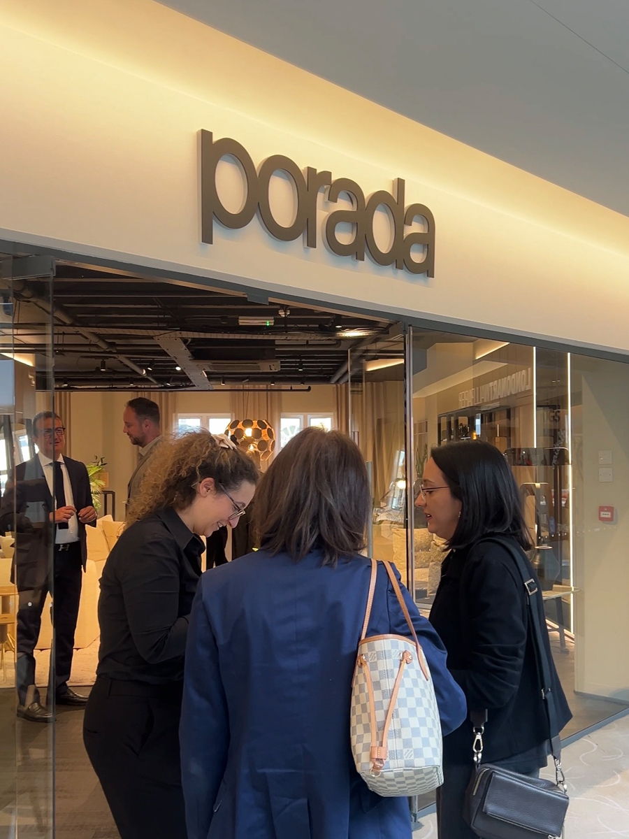 People gathered at the entrance of a store named porad in Chelsea design centre..