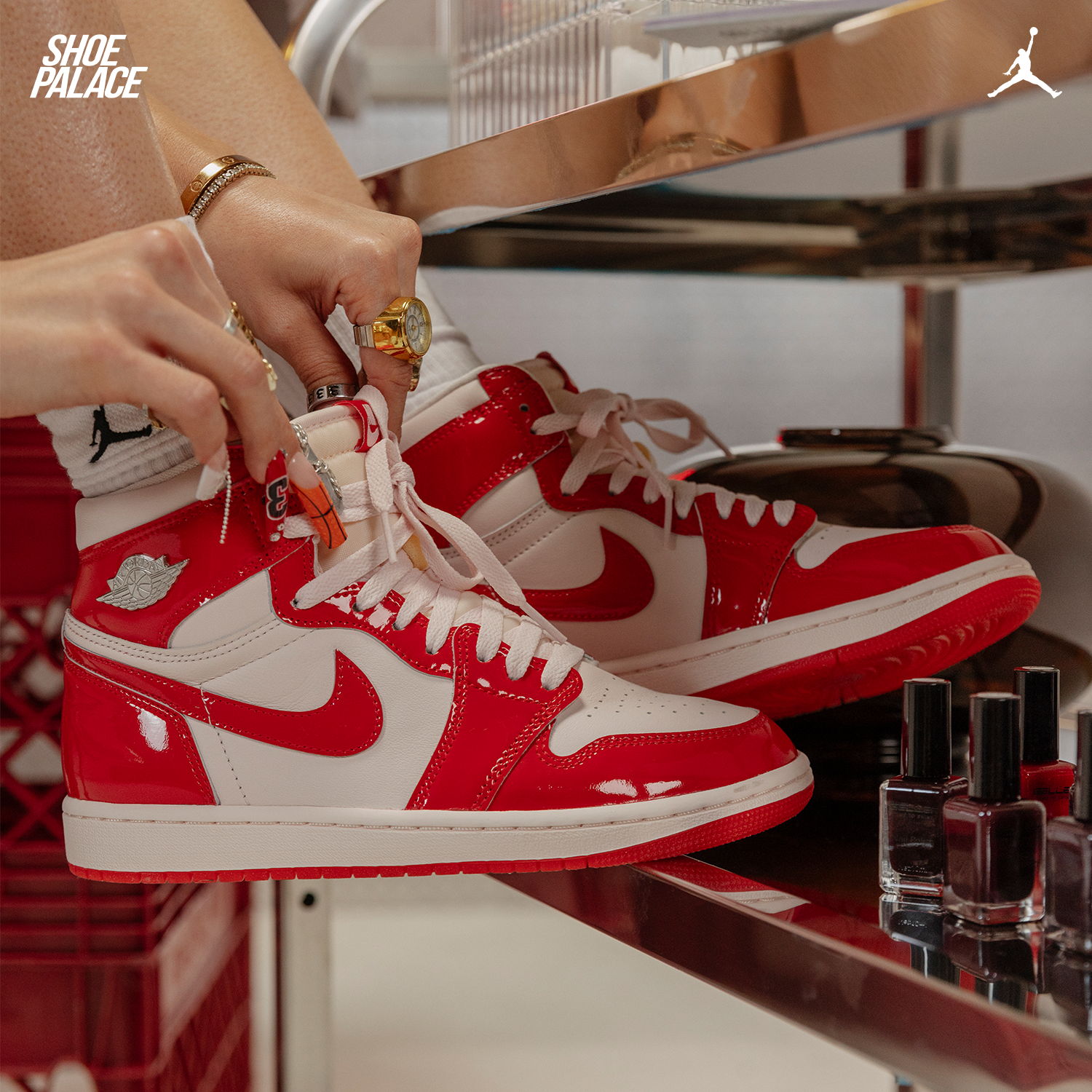 A person putting on red and white Nike sneakers.