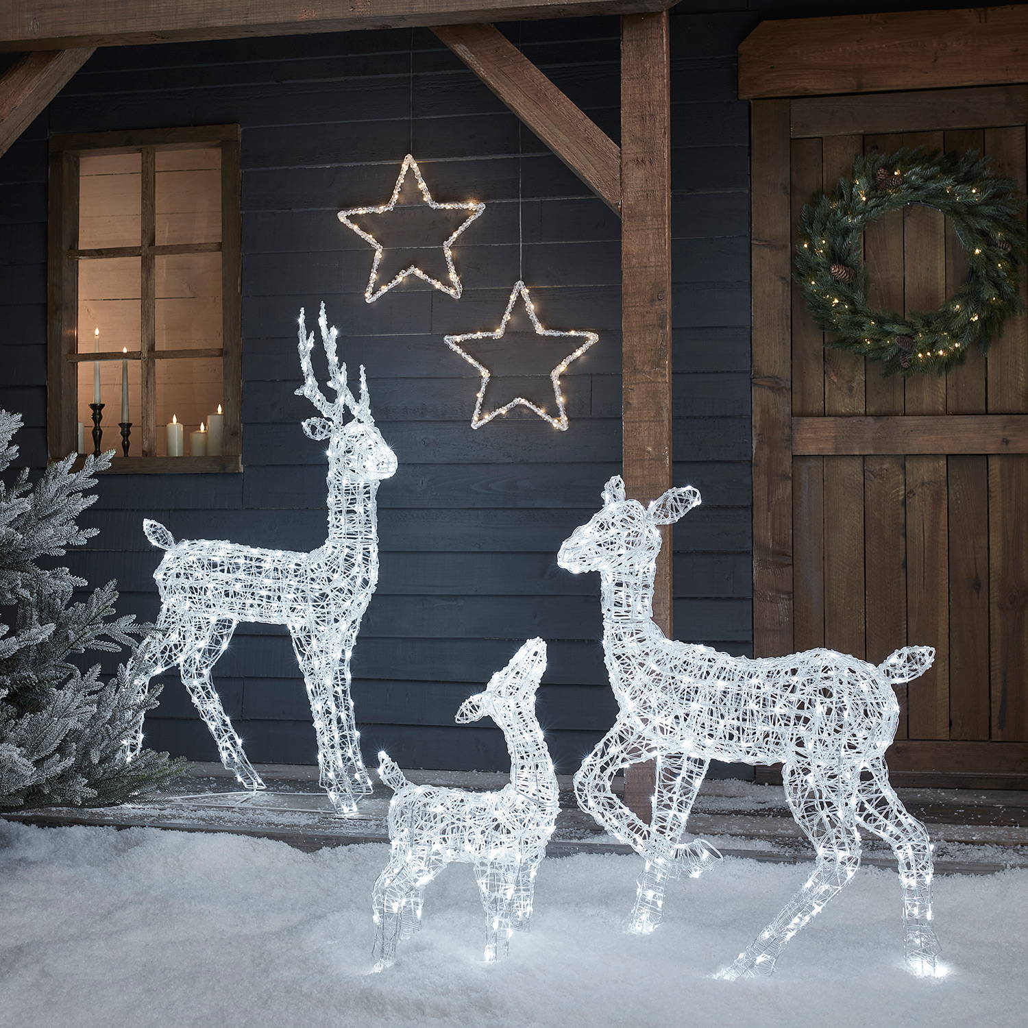 Swinsty light up reindeer family in an outdoor snowy home setting.