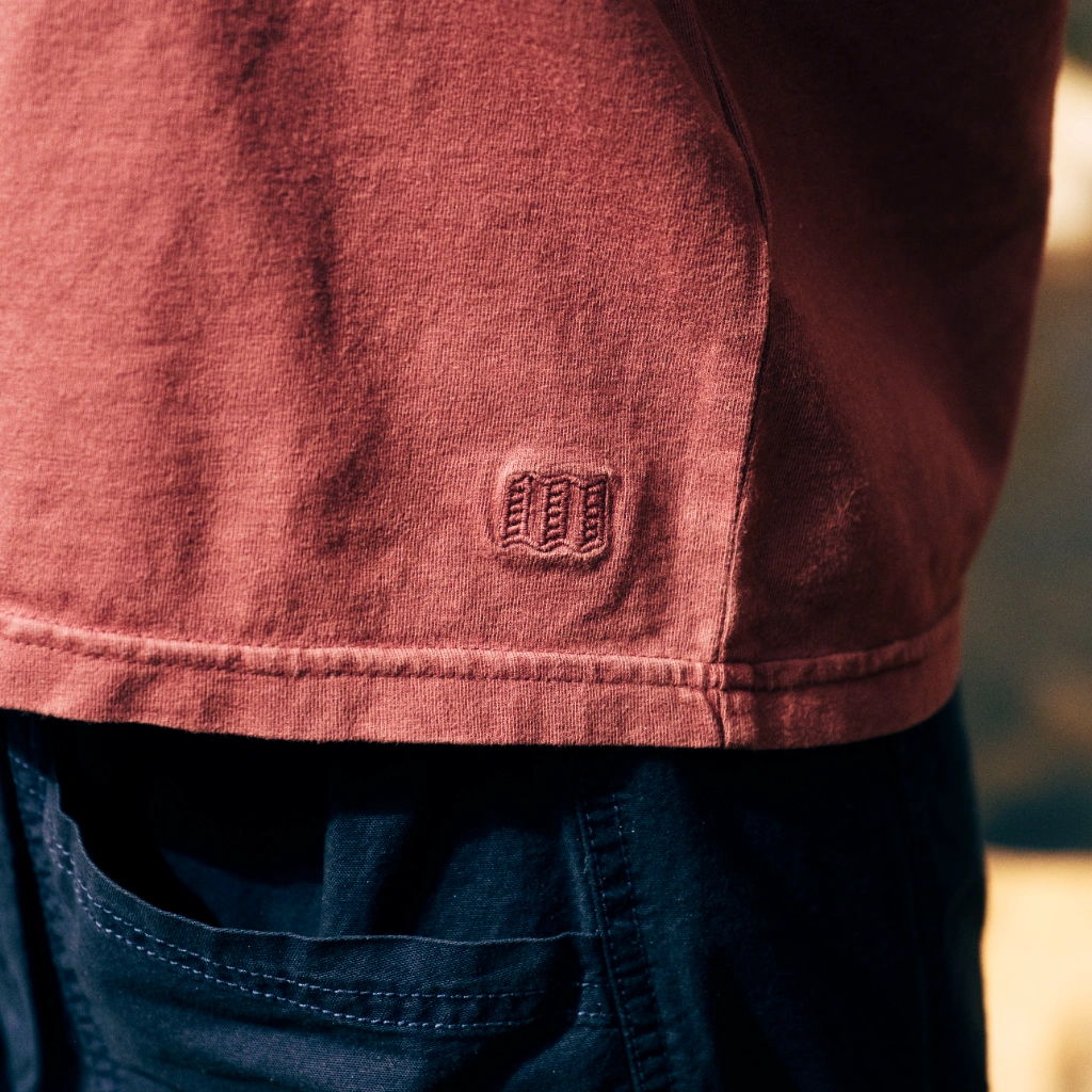 Close-up of a shirt's hem featuring a logo.