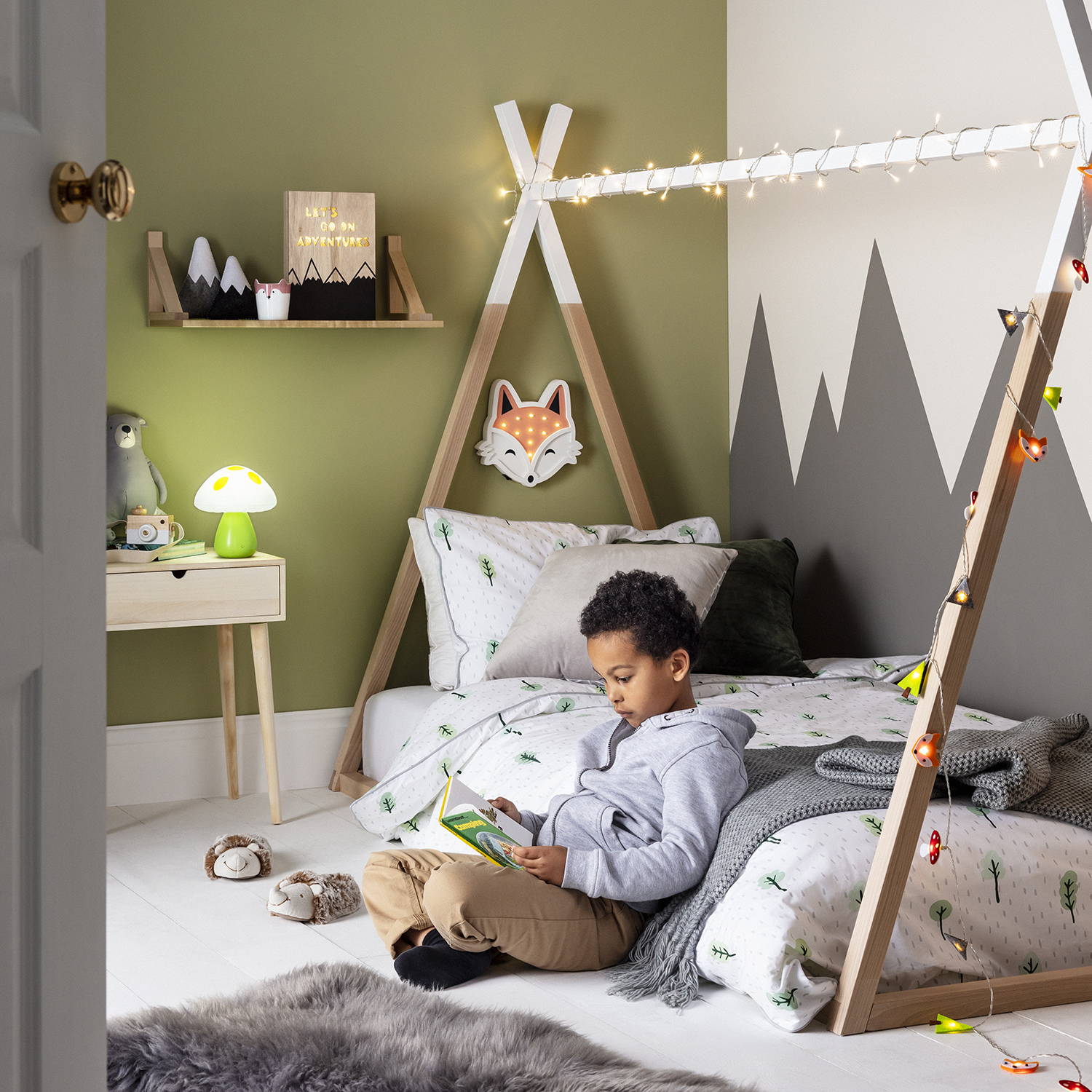 Woodland themed bedroom with fairy lights, table lamps and wall lights displayed